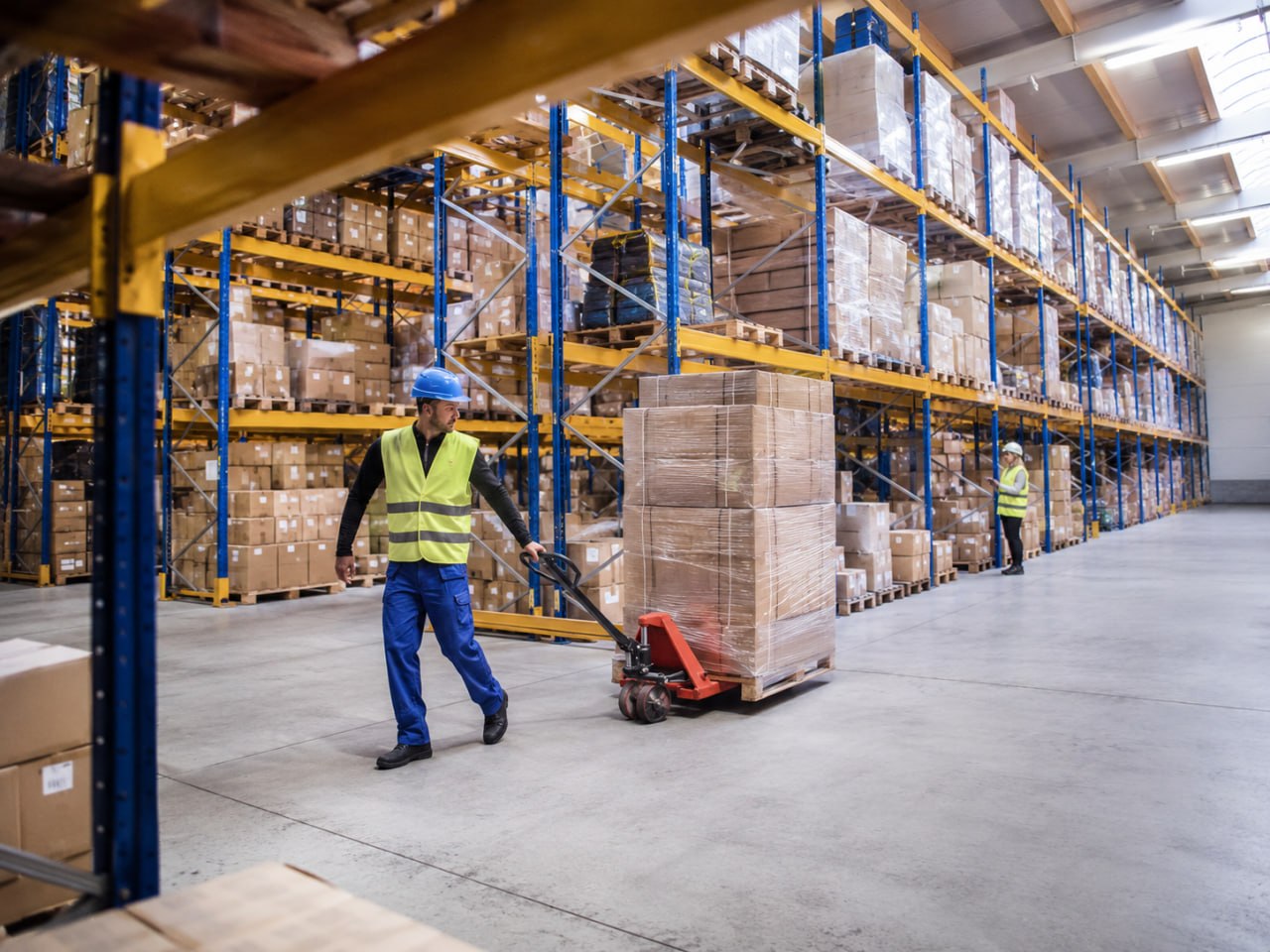 Warehouse associate moving palletized inventory