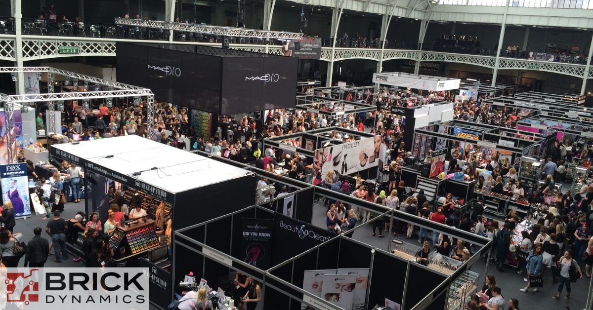 Busy exhibition hall filled with trade show booths and attendees